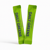 Two green packets of 'Daily Greens' on a white background