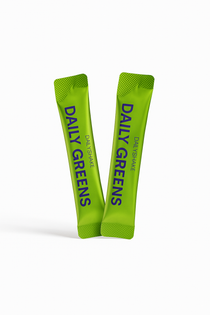 Two green packets of 'Daily Greens' on a white background