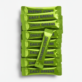 Multiple packages of 'Daily Greens' on a white background